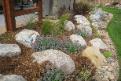 boulder wall and rock garden featuring ornamental grasses
