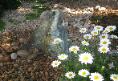 Pondless water feature from granite boulder and daiseys