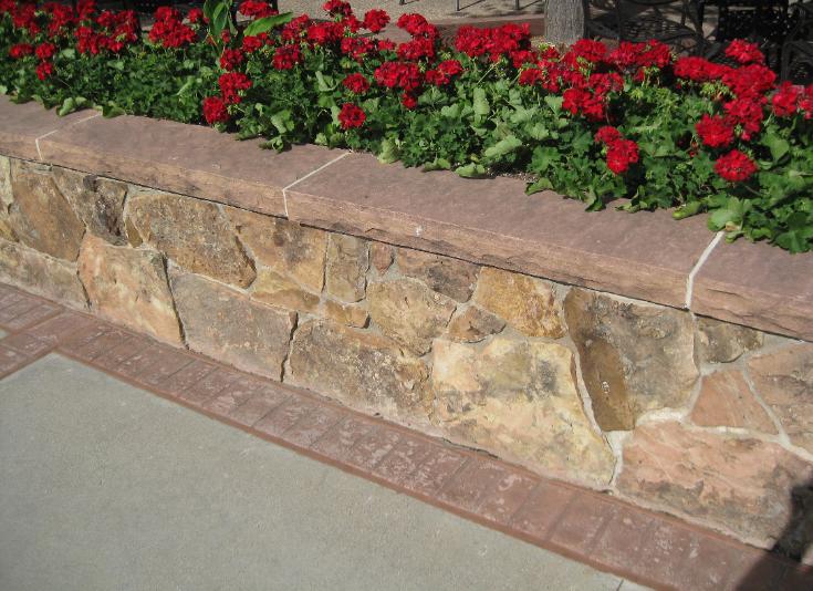 moss rock wall with flagstone cap