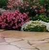 Flagstone patio backed by a perennial garden